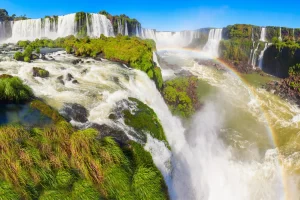 Panoramic view of Iguassu Falls with rainbow and lush greenery in Foz do Iguaçu, Brazil 2025