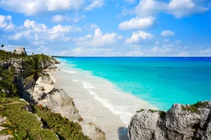 View of Tulum’s beaches and Caribbean coastline with turquoise waters and ancient ruins in the distance