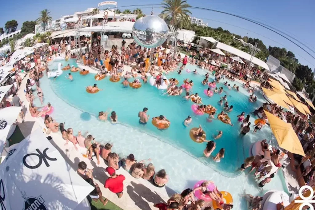 Pool party at O Beach Ibiza during summer 2025 with a vibrant crowd and DJs by the pool.
