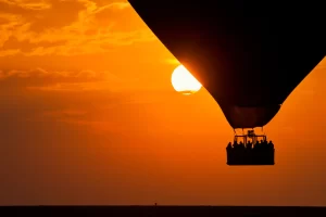 Hot air balloon flying over Ibiza at sunrise, part of the top activities in Ibiza 2025