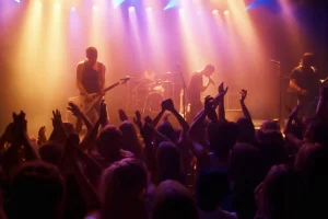 Rock band performing live in front of cheering crowd at a 2025 concert in the USA