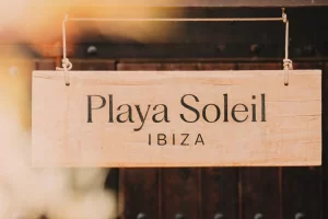 Playa Soleil Ibiza wooden entrance sign, leading to the top Ibiza beach club experience.