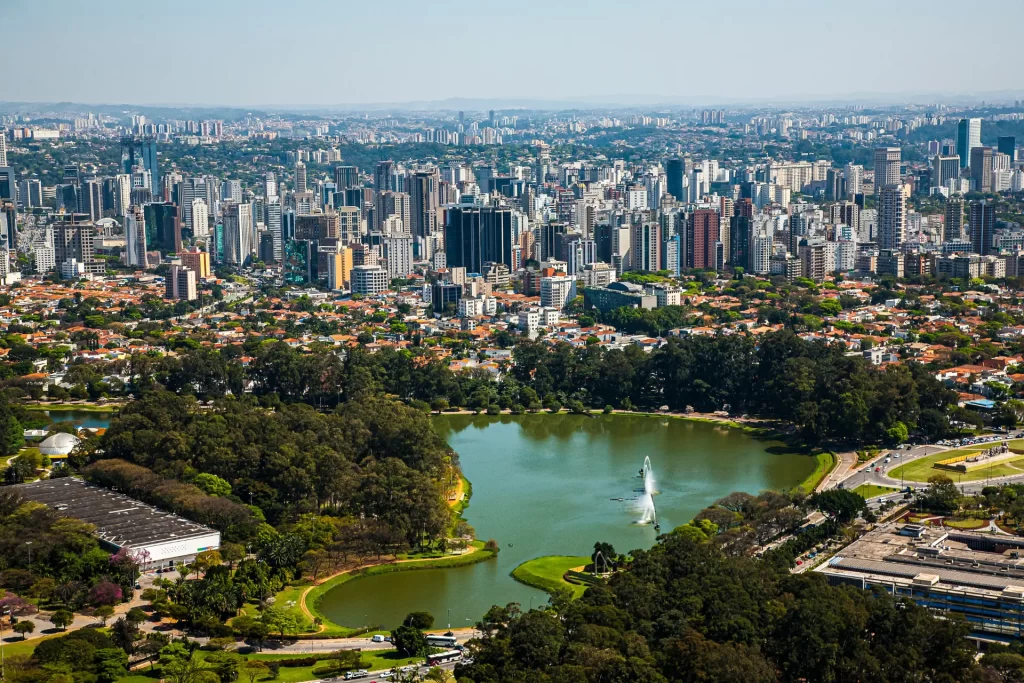 Skyline of São Paulo with lush green trees in the foreground, capturing urban nature in São Paulo.