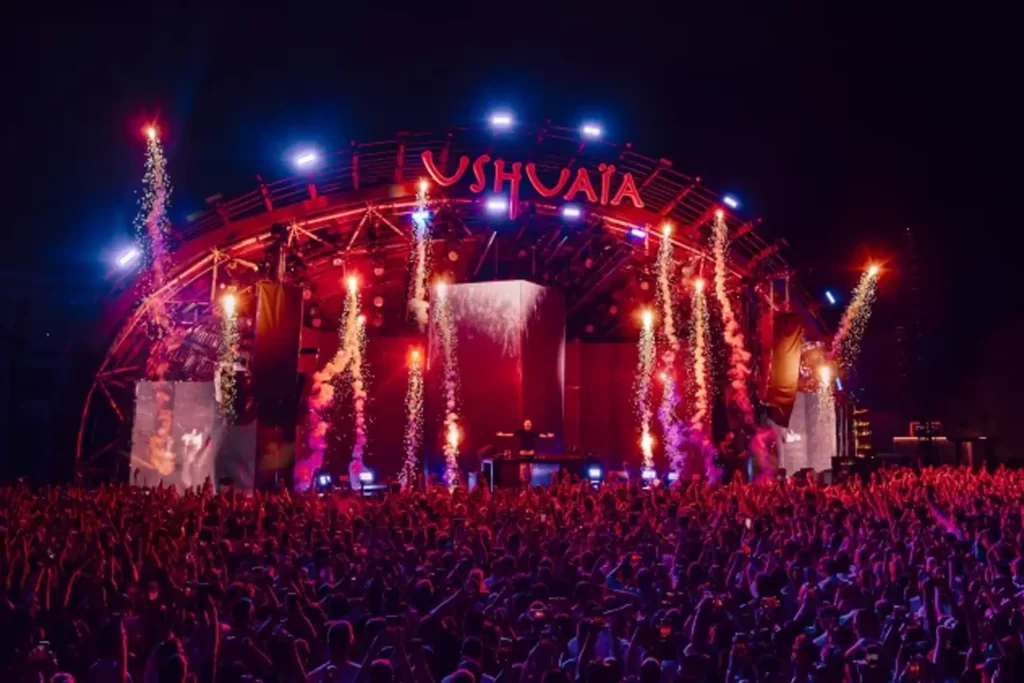 Main stage at Ushuaïa Ibiza during a 2025 party night with fireworks and crowd under vibrant lights.