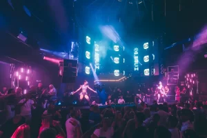 Crowd dancing under lights at Eden Ibiza 2025 superclub in San Antonio