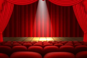 Empty theater stage with red curtains and spotlight for 2025 live performances in the USA