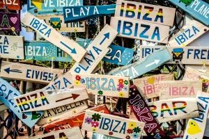 Colorful Ibiza signs pointing to beaches and trails, representing the vibrant spirit of Ibiza forest hiking travel